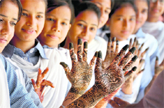 Students of Government Model Senior Secondary School display designs in mehandi applied on their palms as a part of Teej celebrations in Ludhiana. 