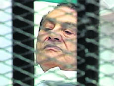 Former Egyptian President Hosni Mubarak is seen in the courtroom for his trial at the Cairo Police Academy 