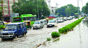 Vehicles drive through a waterlogged stretch at Baba Kharak Singh Marg after a heavy downpour in New Delhi