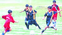 A match under way during rain in the 27th Carbery Memorial Inter-School Sub-junior Football Tournament in Dehradun