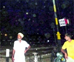 Railway employees inspect the open level crossing near Harbanspura village