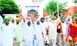 Farmers, who had been booked for protesting against land acquisition for a thermal plant at Gobindpura village, raise slogans after their release from jail on Thursday