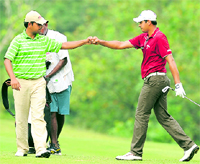 Indias Anirban Lahiri (L) and Gaganjeet Bhullar during the second day of the Omega World Cup Asian Qualifying tournament in Petaling Jaya near Kuala Lumpur on Thursday