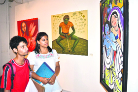 Visitors to an exhibition of paintings in Chandigarh.