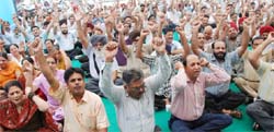 Officials and employees of various nationalised banks raise slogans against the Centre during a rally held in Bathinda