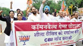 BJP activists hold a demonstration near Parliament in New Delhi on Friday, demanding the resignation of Sheila Dikshit following the CAG report on CWG.