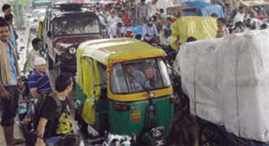 Commuters take shelter under an overbridge during rain in east Delhi on Friday.