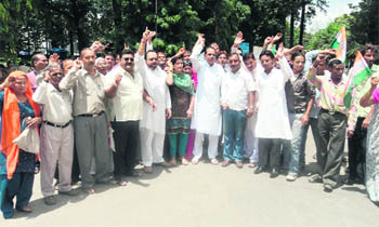 Congress workers hold a protest at the Dehradun Municipal Corporation premises on Friday. 