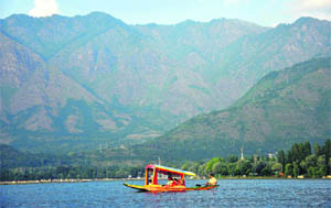 Tourists enjoy a ride on a shikara at the world famous Dal Lake in Srinagar