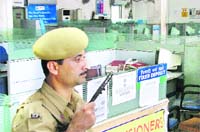 A policeman stands guard at a deserted public sector bank due to the nation-wide one-day strike by bank staff in Ludhiana