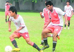 Players vie for the ball during a football match in Chandigarh