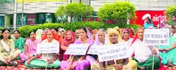 Women stage a dharna demanding cancellation of the licences of the pubs in Sahara Mall in Gurgaon on Saturday