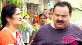 Rajni, mother of Akhilesh, tries to hold back her enraged husband in Ludhiana on Saturday.