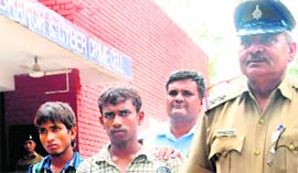 Rajinder Singh, alias Radhe, (left) and Sita Ram (centre) in police custody at the crime branch office in Sector 11, Chandigarh, on Sunday.