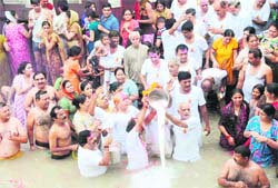 Milk being offered by devotees to the holy Ganga river in Haridwar on Sunday