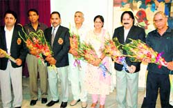 Senior badminton players at a felicitation function in Dehradun on Sunday