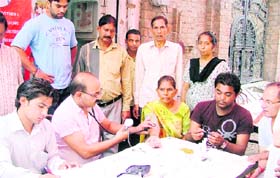 Doctors examine patients at a free diabetes camp at Shivpuri in Ludhiana on Sunday