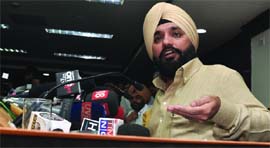 Arvinder Singh Lovely, Delhi minister of education and tourism , addresses a press conference in New Delhi on Monday.