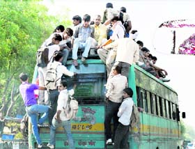An overloaded bus passes through the Gurgaon-Mewat road near Gurgaon.
