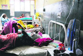 Owing to non-functional ceiling fans in the maternity ward of the Civil Hospital in Karnal, patients use table fans.
