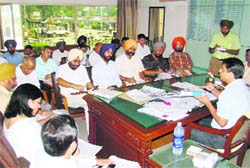 Deputy Commissioner Rahul Tiwari addresses a monthly meeting of district officials in Ludhiana