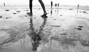 The oil-covered shores of the Juhu beach in Mumbai. The authorities worked to clean up the oil spill from a cargo ship that sank off the shores last week. 