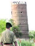 A BSF soldier stands guard at the Sadqi post near Fazilka opposite the Pakistani observation post