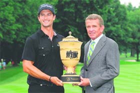 Australias Adam Scott poses with the trophy alongside PGA TOUR commissioner Tim Finchem after the final round of the World Golf Championships-Bridgestone Invitational in Akron, Ohio on Sunday