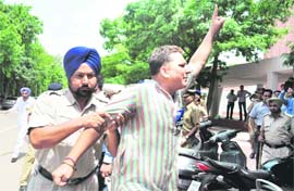 A representative of the Akhil Bharatiya Vidyarthi Parishad being stopped by a policeman from urging students on the Panjab University campus to boycott their classes