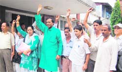 Samajwadi Party workers hold a protest in front of the office of the Jal Sansthan in Dehradun 