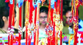 Rakhis on display at a stall in a busy market in Jammu.