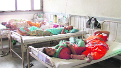 Patients sharing a bed in the female ward of the Civil Hospital in Ludhiana.
