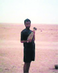 A Jalandhar youth holding a live bombshell at an undisclosed location in Iraq