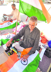  A tailor stitches a National Flag for the Independence Day celebrations, in Patiala on Tuesday