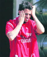 Arsenals Cesc Fabregas rubs his head as he arrives for a team training session at London Colney on Tuesday. 