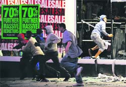 Rioters run away after ransacking a store in Peckham. 