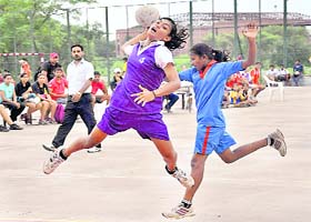 A player of GMSSS-21 about to score a goal against Sacred Heart in the handball tournament in Chandigarh on Wednesday