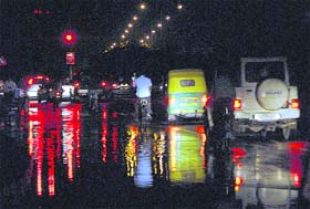 Lights reflected in water create a beautiful view on a road after rain in Chandigarh on Wednesday