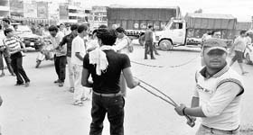 Protesters line up with a rope to block the highway