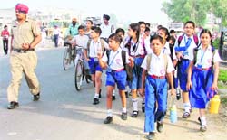 Students of Greenland School were forced to walk to their school after the driver of the bus they were commuting refused to move ahead fearing a challan by the police