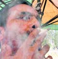A man puffs a cigarette at a public place in Ludhiana