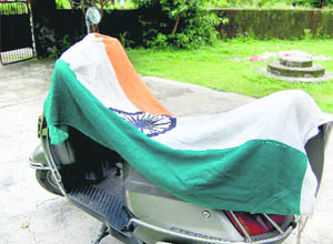 The National Flag placed on a scooter for drying at a regional office of the Municipal Corporation, near the Vidhan Sabha, in Dehradun
