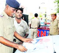 A police official issues a challan in Rohtak. 