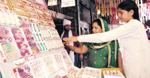 Women buy rakhis at the Karan Gate Market in Karnal
