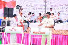 Officials of the Town Planning Department hold a draw of lots for EWS flats at Dharuhera in Rewari district