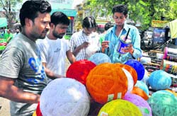 Youths purchase threads for flying kites in Jammu on Thursday