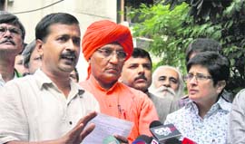 Arvind Kejriwal, Swami Agnivesh and Kiran Bedi address the media in Noida on Thursday.