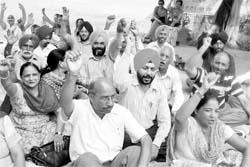 Members of the Government College Teachers Association stage a dharna in support of their demands at Government Mohindra College in Patiala on Friday