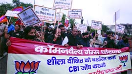 BJP party members protest against Delhi Chief Minister Sheila Dikshit on the issue of alleged corruption in the Commonwealth Games, outside the Civic Centre in New Delhi on Friday.