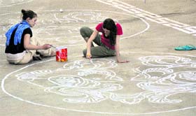 Foreign tourists paint on the floor of the Thiksy Monastery in Leh.